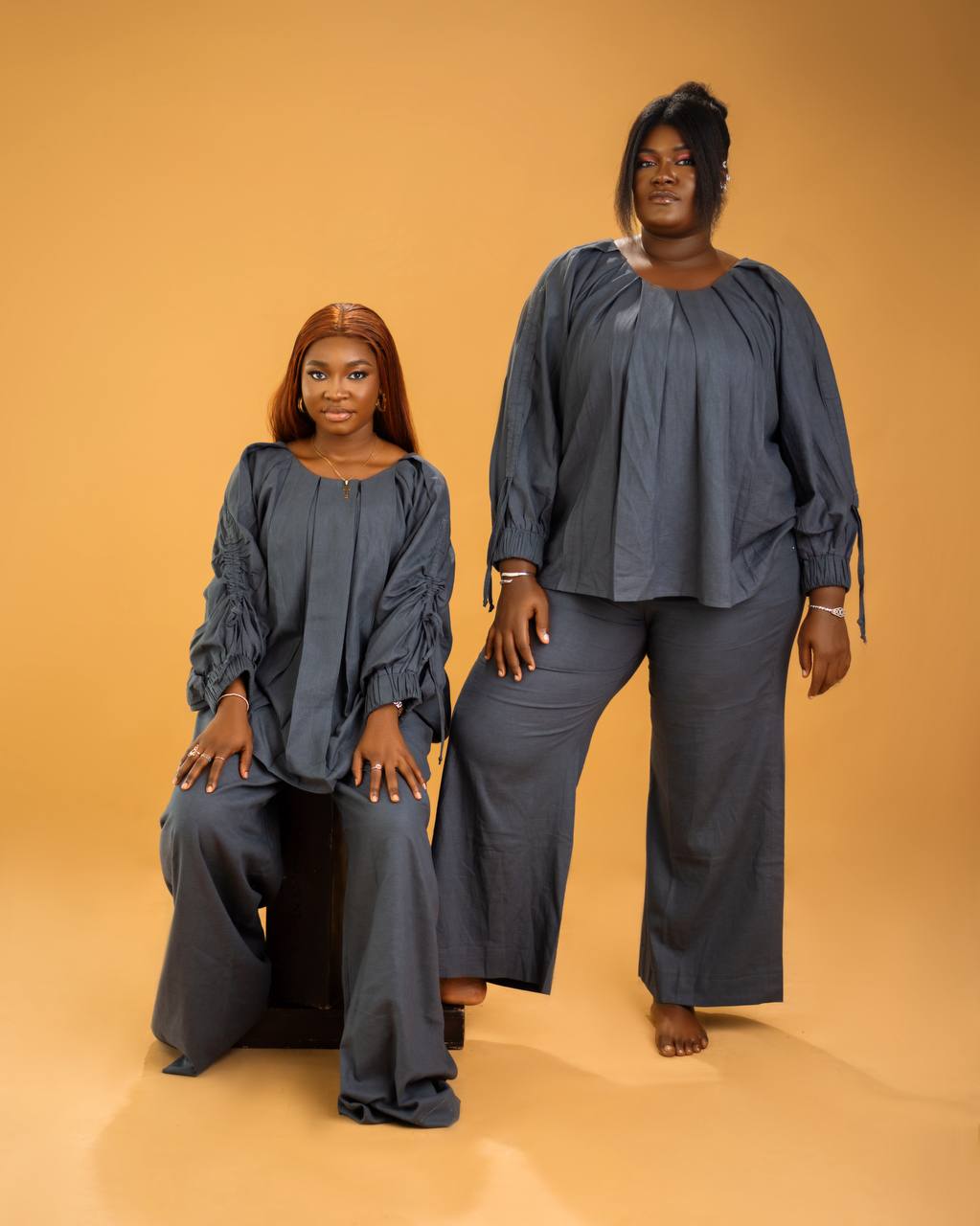 Macro shot of embroidered fabric details showing intricate gold stitching on navy blue silk